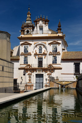 Reflection of San Jorge Church at Hospital de le Caridad Seville Spain in fountain pool
