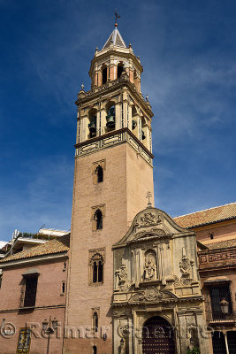 Facade and bell tower of the church of Saint Peter at Plaza de san Pedro in Seville Spain