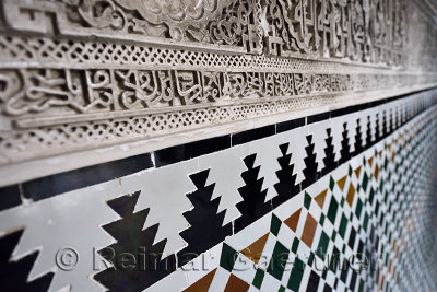 Close up of ancient arabic wall carving and tilework at Alcazar palace Seville Andalusia