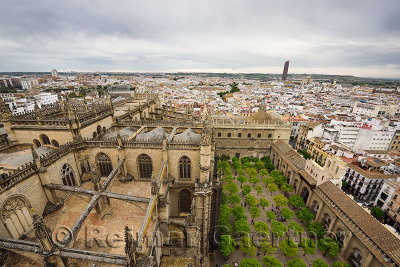 Wide view west from Giralda tower with roof of Seville cathedral and orange tree courtyard