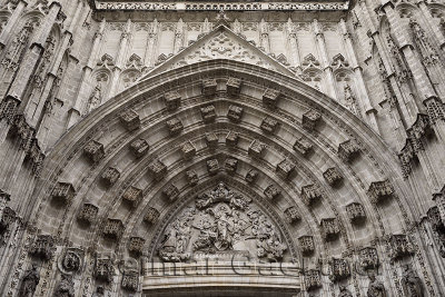 Carved relief of the Assumption of Saint Mary above main door at the Seville cathedral Andalusia