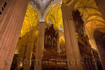 Choir area with two sets of organ pipes and lofted ceilings in the Seville Cathedral