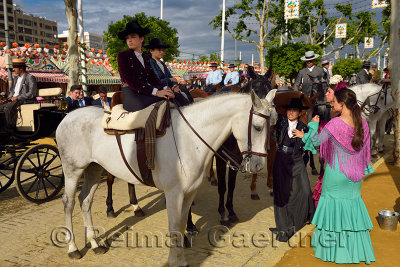 Women riding horses side saddle at the Seville April Fair Andalusia