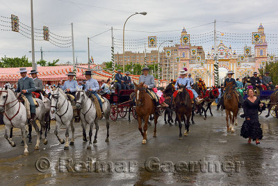Horseback riders at the Seville April Fair with Main Gate 2015 on Antonio Bienvenida street