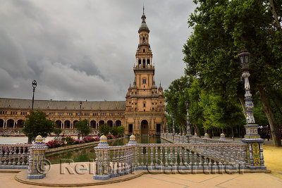 Painted ceramic railing along canal with South Tower at Plaza de Espana Seville Spain