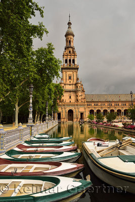 Row boats in canal with North tower at Plaza de Espana Seville Spain