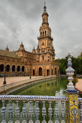 South tower from a bridge with painted ceramic over the canal at Plaza de Espana Seville Spain