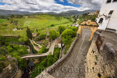 Arch of Felipe V with old Arab bridge and Arab Bath ruins in the city of Ronda Spain