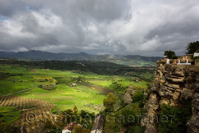 Dappled sunshine on green farm fields in spring at El tajo gorge from Mondragon Palace Ronda Spain