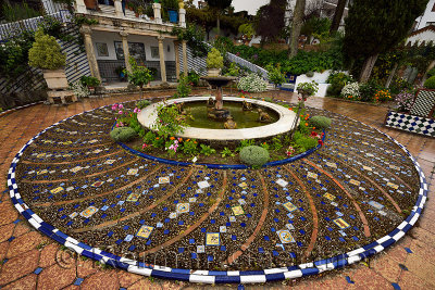 Wet stones and tiles of circular garden fountain at Mondragon Palace Ronda Museum Andalusia