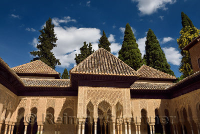 Ornate stiled arches in the courtyard of the Lions at Nasrid Palaces Alhambra Granada