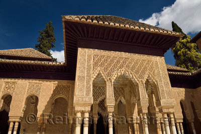 Ornately decorated stiled arches in the courtyard of the Lions at Nasrid Palaces Alhambra Granada