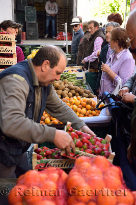 Granada locals waiting in early morning for fresh produce off the truck 