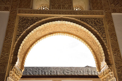 Arched entranceway with arabesque caligraphy to the court of the Lions Nasrid Palaces Alhambra Granada