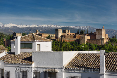 Albaicin whitewashed houses with Alcazaba fortress at Alhambra Palace and Sierra Nevada Mountains Granada