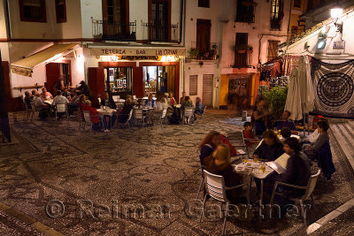 Outdoor patios at night in Plaza San Gregorio on Caldereria Nueva street Granada