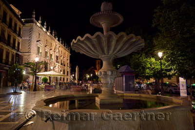 Fountain in Plaza Nueva at night with Royal Chancery of Granada and church of Santa Ana
