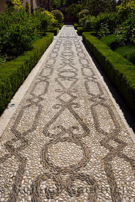 Black and white stone mosaic patterned garden walkway of San Francisco convent at Alhambra Palace Granada