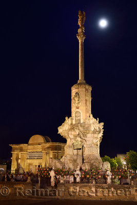 Saint Raphael archangel triumph statue at the Bridge Gate in Cordoba with moon at night