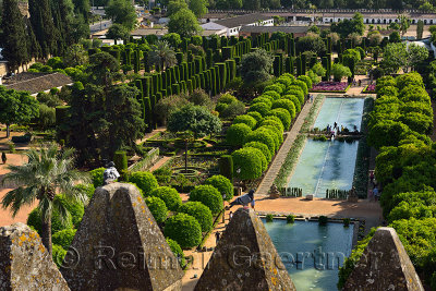 View of gardens and ponds through Tower of Lions merlons Alcazar Cordoba