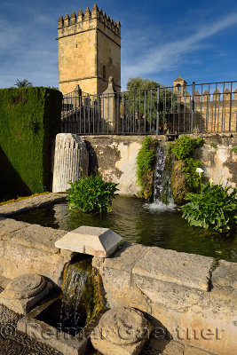 Waterfall from upper to lower ponds with Tower of the Lions at Alcazar Cordoba