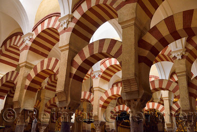 High ceiling with double arches of white stone and red brick at the Prayer Hall of Cordoba Cathedral Mosque