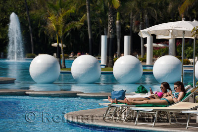 Two young woman lounging by the pool in Nuevo Vallarta Mexico
