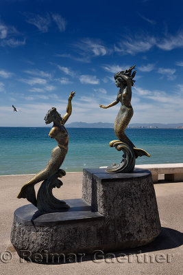 Triton with broken arm and Mermaid statues on the Malecon Puerto Vallarta Mexico