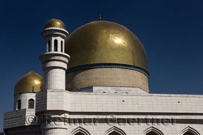 Golden domes and Turkish caligraphy of Central Mosque in Almaty Kazakhstan