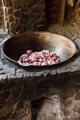Outdoor stone cooking oven fit with steel bowl with raw lamb Kazakhstan