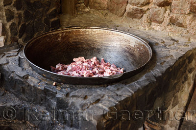 Outdoor stone cooking oven fit with raw lamb in steel bowl Turgen Kazakhstan