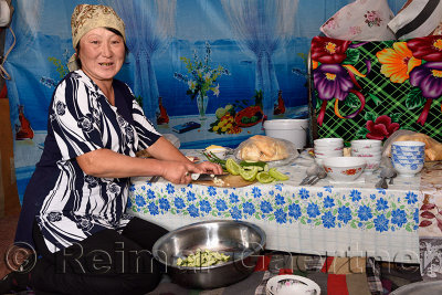 Kazakh woman preparing lunch for guests inside a yurt on the Assy Plateau Kazakhstan