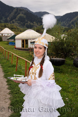 Young woman with traditional Kazakh dress with candies for Shashu greating Kazakhstan