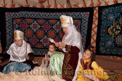 Grandmothers and children in a yurt beating and spinning wool Huns village Kazakhstan