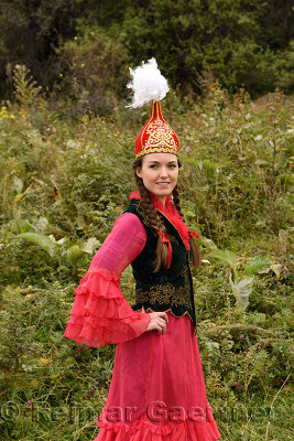 Young woman in traditional Kazakh dress with Takiya skull cap with feathers Kazakhstan