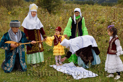 Tusau Kesu cutting the rope Kazakh traditional family ceremony with young child