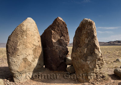 Three standing stones in Altyn Emel Park called Oshak Tas a burial mound or fire pit of Genghis Khan