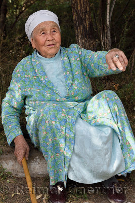 Kazakh grandmother sitting at a rest stop on Highway A353 to Altyn Emel National Park Kazakhstan