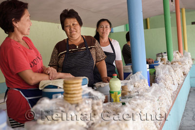 Women selling kumis and dry salty kurt cheese balls at road side stand near Altyn Emel Park Kazakhstan