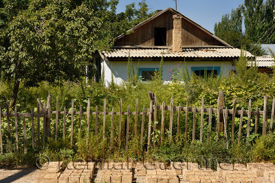 House with picket fence and mud bricks in Kalinino Basshy village Kazakhstan