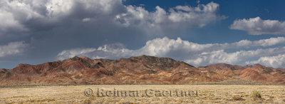 Panorama of red Katutau hills and steppe in Altyn Emel National Park Kazakhstan