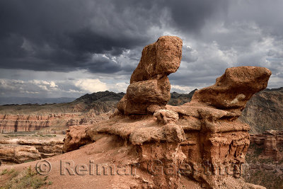Dark clouds over red sandstone hoodoo at Charyn Canyon National Park Kazakhstan