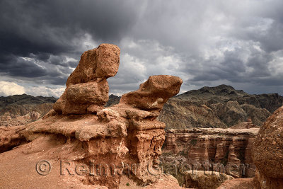 Dark clouds over sculpted red sandstone at Charyn Canyon National Park Kazakhstan