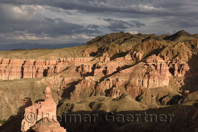 Couple taking picture at sunset on top of Hoodoo at Charyn Canyon Kazakhstan