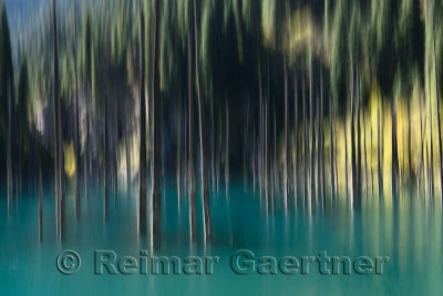 Blurred trees of turquoise Lake Kaindy Kazakhstan in the Fall