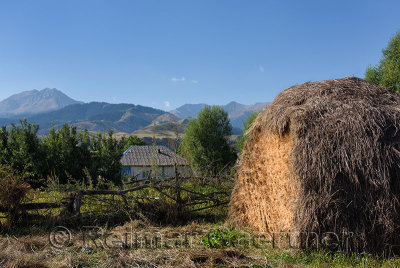 Half used hay stack and Kungey Alatau mountain range from Saty village Kazakhstan