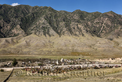 Muslim cemetery in valley near Saty Kazakhstan with Kungey Alatau mountain range