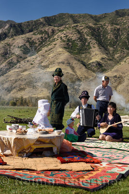 Saty townspeople in traditional garb sing at a picnic in the Chilik river valley Kazakhstan