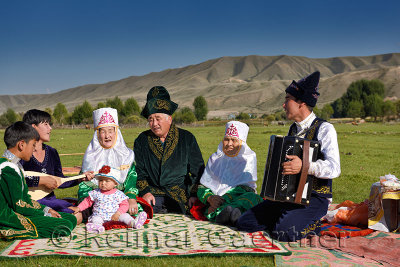 Traditional Kazakh family singing at a picnic in pastureland of Saty Kazakhstan