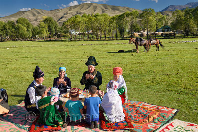 Traditional Kazakh family saying grace at a picnic in Chilik river valley Saty Kazakhstan